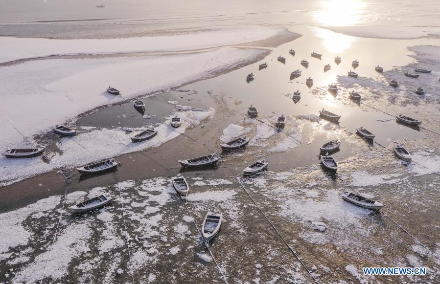 Aerial photo taken on Dec. 14, 2020 shows the snow scenery of a coastal park in Rongcheng City, east China's Shandong Province. Snow has fallen in many parts of the country in recent days. (Photo by Li Xinjun/Xinhua)