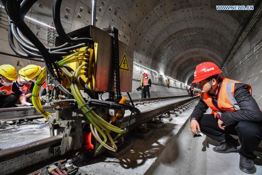 Zhou Tao (1st R), manager of the rail welding branch of China Railway 11th Bureau Group Third Engineering Co., Ltd., inspects the construction site of the Guangzhou Metro Line 18 in Guangzhou, south China's Guangdong Province, on Dec. 16, 2020. A total of 122.6 kilometers of railway tracks will need to be laid for the Guangzhou Metro Line 18, a subway line which is under construction with a maximum designed speed of 160 kilometers per hour. (Xinhua/Liu Dawei)