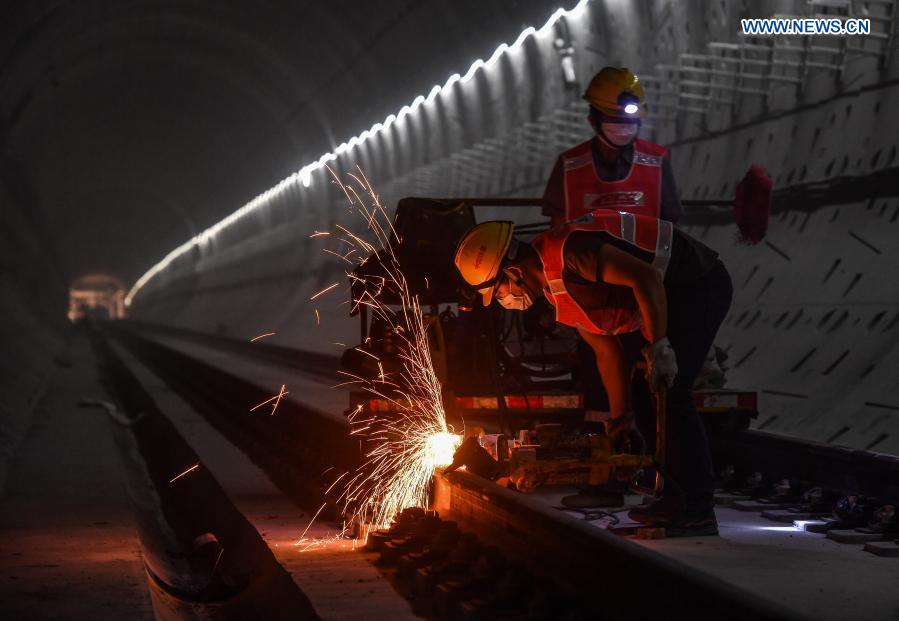 Workers work at the construction site of the Guangzhou Metro Line 18 in Guangzhou, south China's Guangdong Province, on Dec. 16, 2020. A total of 122.6 kilometers of railway tracks will need to be laid for the Guangzhou Metro Line 18, a subway line which is under construction with a maximum designed speed of 160 kilometers per hour. (Xinhua/Liu Dawei)