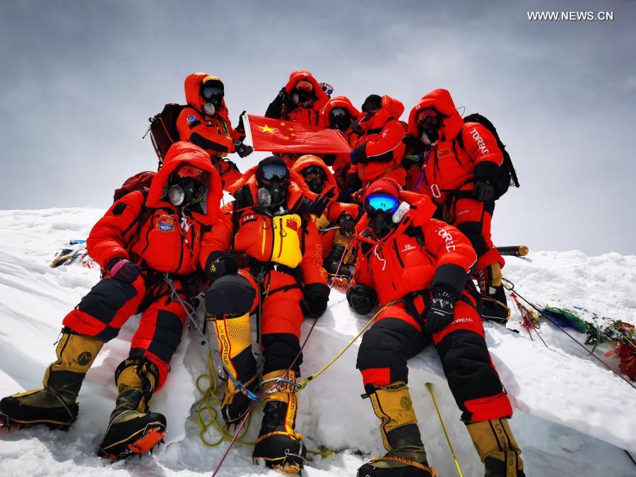 Chinese surveyors pose for a group photo atop Mount Qomolangma on May 27, 2020. The new height of Mount Qomolangma, the world's highest peak, is 8,848.86 meters, China and Nepal jointly announced on Dec. 8. Looking back at 2020, there are always some warm pictures and touching moments: the dedication on the front line to fight against the epidemic, the perseverance on the way out of poverty, the courage to shoulder the responsibility on the embankment against the flood, the joy and pride when reaching the summit of Mount Qomolangma... These people and things touch our hearts and give us warmth and strength. (Xinhua/Tashi Tsering)