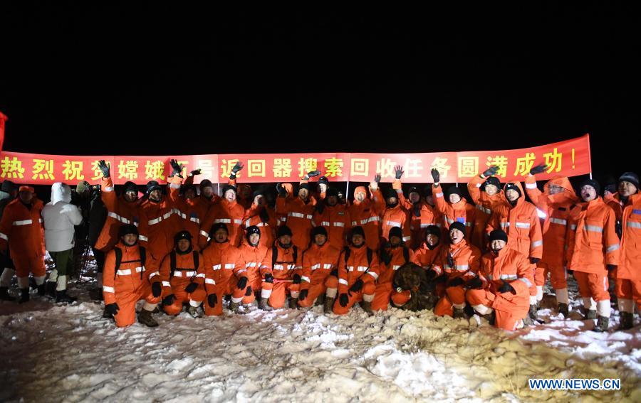 Staff members pose for a group photo at the landing site of the return capsule of China's Chang'e-5 probe in Siziwang Banner, north China's Inner Mongolia Autonomous Region, Dec. 17, 2020. The return capsule of China's Chang'e-5 probe touched down on Earth in the early hours of Thursday, bringing back the country's first samples collected from the moon, as well as the world's freshest lunar samples in over 40 years. (Xinhua/Lian Zhen)