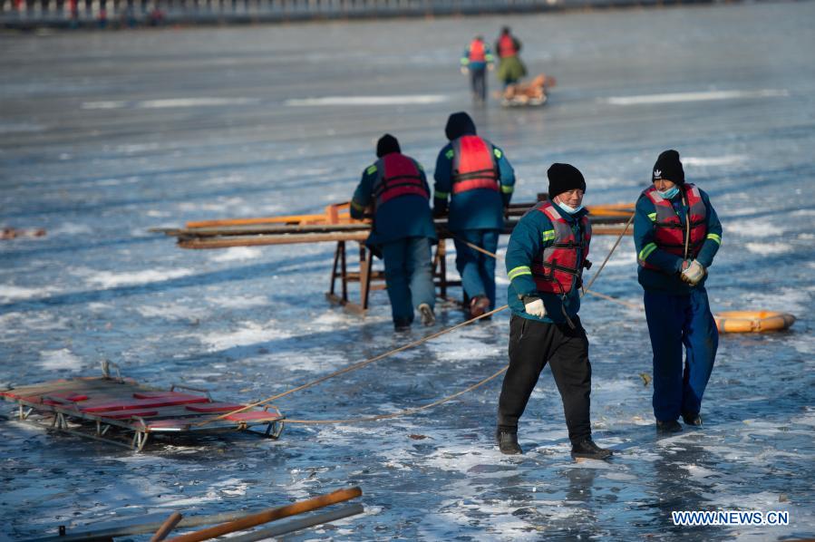 Staff members work on the ice-covered Shichahai Lake in Beijing, capital of China, Dec. 13, 2020. (Xinhua/Chen Zhonghao)