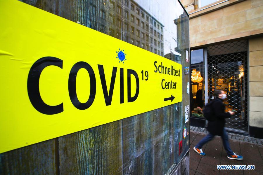 A sign leading to a Covid-19 test center is seen in Frankfurt, Germany, on Dec. 16, 2020. Germany will go into stricter lockdown from Wednesday, closing non-essential shops and limiting the size of private gatherings, Chancellor Angela Merkel and regional leaders agreed on Sunday. The tighter restrictive measures, which will be effective until Jan. 10, were in response to an 