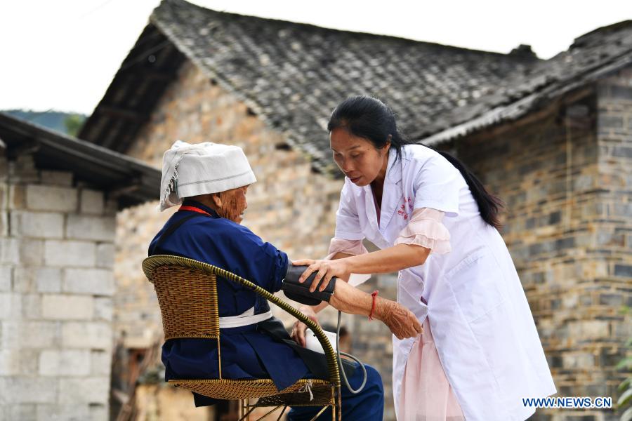 Doctor Luo Mu measures blood pressure for a villager in Cuiwei Village of Longli County, Qiannan Buyi-Miao Autonomous Prefecture, southwest China's Guizhou Province, Aug. 18, 2020. The year 2020 is a juncture where China is wrapping up the plan for the 2016-2020 period and preparing for its next master plan. In 2020, China stepped up efforts to shore up weak links regarding people's livelihoods. A slew of measures has been rolled out to address people's concerns in employment, education, basic medical services, the elderly care, housing, public services, etc. (Xinhua/Yang Wenbin)