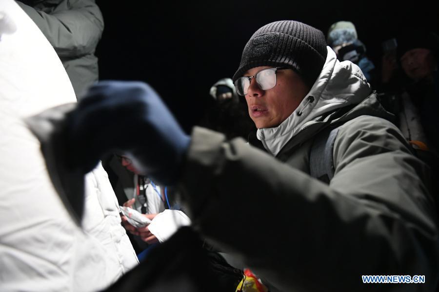 A staff member works at the landing site of the return capsule of China's Chang'e-5 probe in Siziwang Banner, north China's Inner Mongolia Autonomous Region, on Dec. 17, 2020. The return capsule of China's Chang'e-5 probe touched down on Earth in the early hours of Thursday, bringing back the country's first samples collected from the moon, as well as the world's freshest lunar samples in over 40 years. (Xinhua/Lian Zhen)