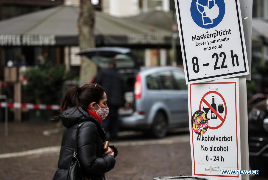 Signs reminding people to wear facial masks and to avoid alcohol drinking in public places are seen on a street in Frankfurt, Germany, on Dec. 16, 2020. Germany will go into stricter lockdown from Wednesday, closing non-essential shops and limiting the size of private gatherings, Chancellor Angela Merkel and regional leaders agreed on Sunday. The tighter restrictive measures, which will be effective until Jan. 10, were in response to an 