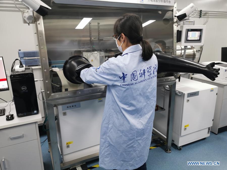 Photo taken on Nov. 30, 2020 shows a staff member adjusting an experimental installation in a laboratory for moon samples at the National Astronomical Observatories of the Chinese Academy of Sciences in Beijing, capital of China. The moon samples collected by China's Chang'e-5 probe will be unsealed at the laboratory. (Image Society of Science and Technology, CAS/Handout via Xinhua)