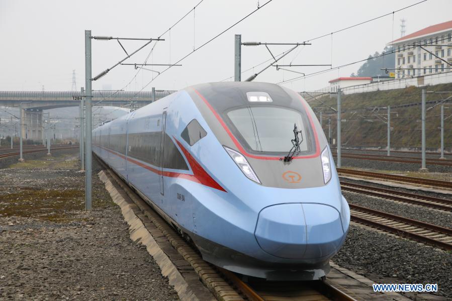 A CR300AF bullet train departs from the Guiyang North Railway Station in Guiyang City, southwest China's Guizhou Province, Dec. 21, 2020. A new-type Fuxing bullet train CR300AF, with a designed speed of 250 km per hour, set off from Guiyang to Liupanshui on Monday, which marked the debut of this type in the southwest China. (Xinhua/Liu Xu)