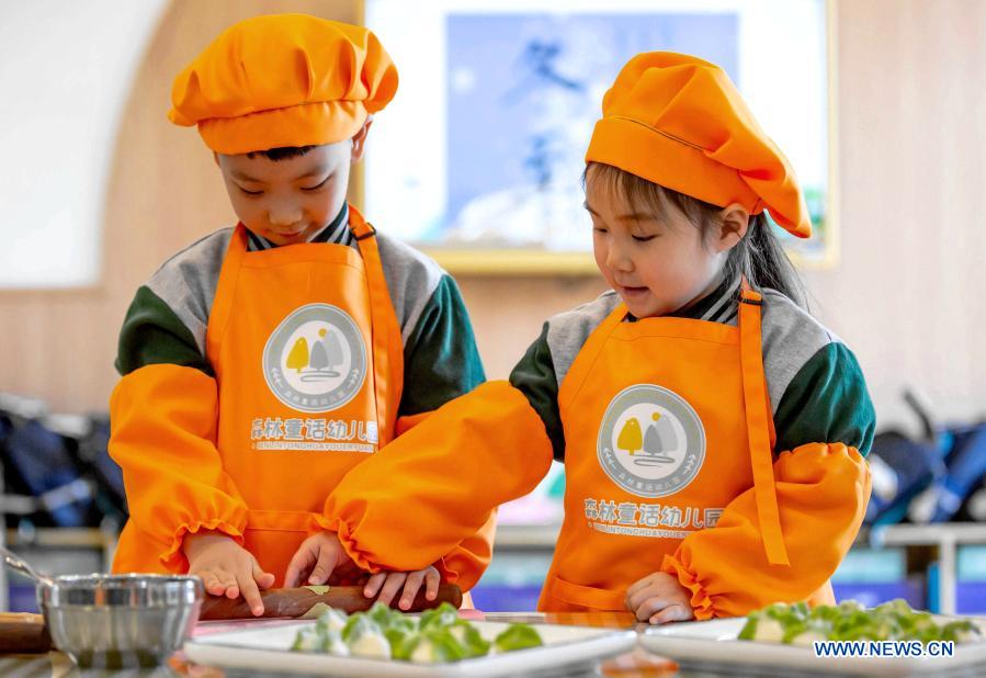 Children learn to make dumplings in celebration of the Winter Solstice or Dongzhi in their kindergarten in Wu'an, north China's Hebei Province, Dec. 21, 2020. Winter Solstice, the shortest day of the year, falls on Dec. 21 or 22. In Chinese culture, it marks the beginning of deep winter and a break from farming in traditional agricultural society. It is also a time for family gatherings. Northern China has maintained the tradition of eating dumplings on this day, while people in southern China eat tangyuan, or rice ball soup. (Xinhua/Wang Xiao)