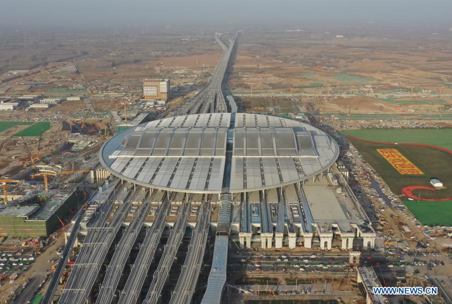 Aerial photo taken on Dec. 23, 2020 shows the construction site of Beijing-Xiongan intercity railway's Xiongan Railway Station in Xiongan New Area, north China's Hebei Province. The construction of Beijing-Xiongan intercity railway's Xiongan Railway Station has entered the final stage and the station will be put into operation by the end of this year. (Xinhua/Mu Yu)