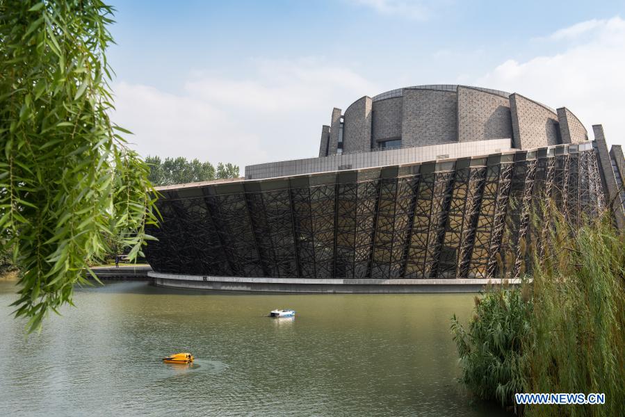 A cleaning boat (white) and a water quality monitoring boat (yellow) supported by 5G and autopilot technologies are in service beside the Wuzhen Grand Theater in Wuzhen, east China's Zhejiang Province, Oct. 19, 2019. With the development of new technologies such as the 5G, artificial intelligence and BeiDou Navigation Satellite System (BDS), unmanned technology is injecting impetus into traditional industries as well as making people's life easier and more convenient in China, and bringing about profound innovation and transformation. From commerce, agriculture, transportation, industrial production to environmental protection, China has been embracing this emerging technology in various fields in recent years as it strives to promote high-quality development. (Xinhua/Zhang Xiaoyu)