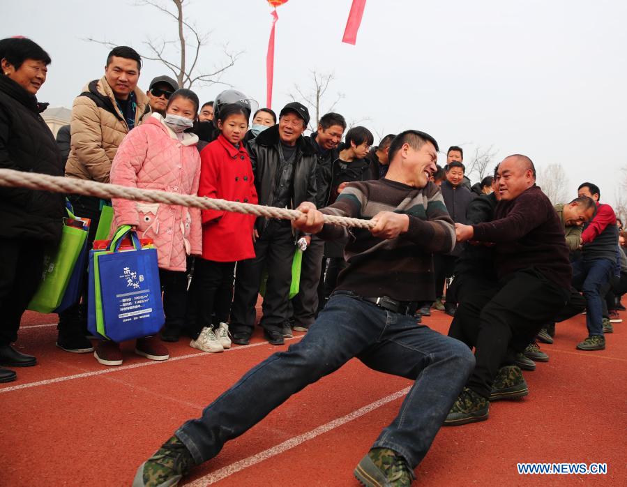 Farmers take part in a tug-of-war game in Yaogou Township of Sihong County in Suqian, east China's Jiangsu Province, Dec. 27, 2020. The fun games, held annually in Yaogou Township before the New Year's Day since 2018, consist of eight interesting competitions which are close to farmers' life this year. (Photo by Xu Changliang/Xinhua)