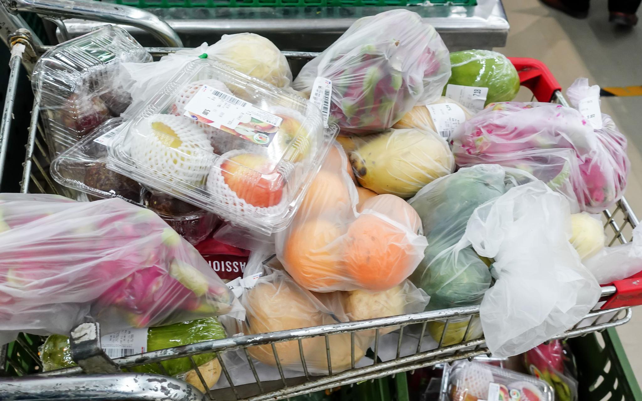 11月14日,物美超市惠新店,一辆购物车里放满了用塑料连卷袋包装的果蔬