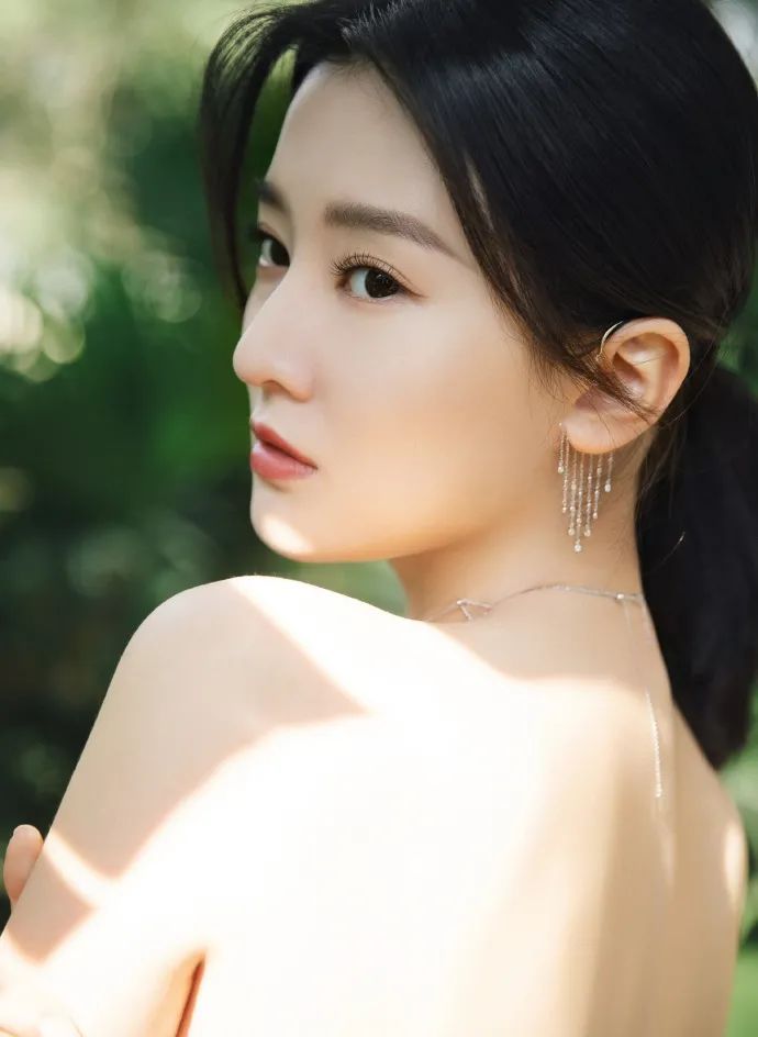 乔欣这套写真特意露出自己光滑香肩与后背,她还戴着小项链和小耳饰,让