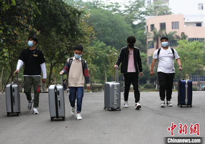 学生推着行李返回宿舍。 朱柳融 摄