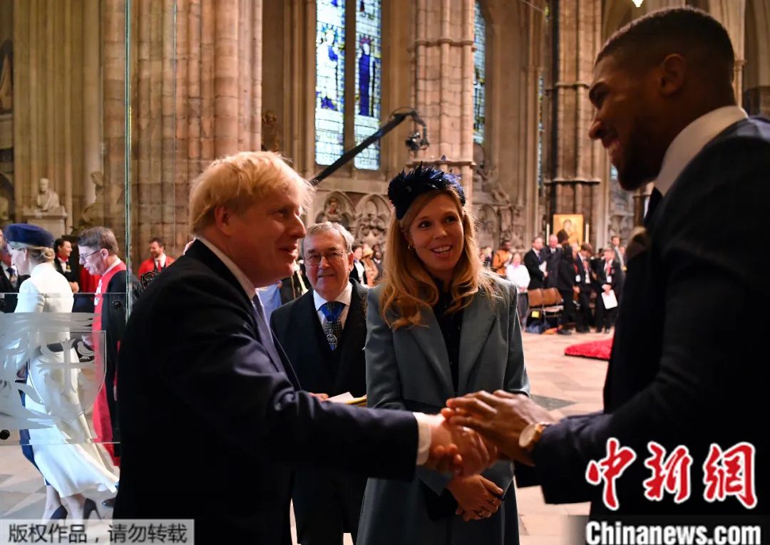 当地时间3月9日,在伦敦威斯敏斯特教堂举行的英联邦日仪式上,约翰逊和未婚妻西蒙兹与英国拳击手安东尼·约书亚交谈。