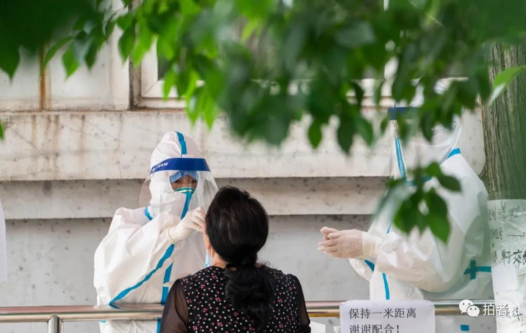 △6月17日,北京大学首钢医院,医护职员为市民收罗咽拭子。