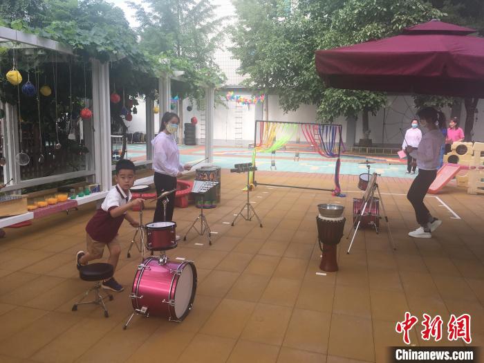 从6月8日起，北京市具备开园条件的北京市幼儿园陆续开园。图为幼儿在园中敲打乐器。　张兴龙 摄