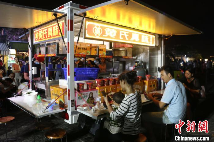 在广西柳州市,用于夜市中售卖螺蛳粉的五菱翼开启售货车。 林馨 摄
