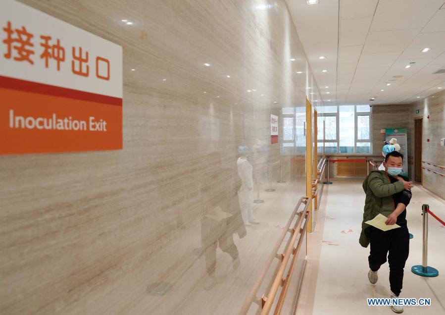 A man walks to the observation room to wait after receiving the COVID-19 vaccine at a healthcare center in Honglian Community in Xicheng District of Beijing, capital of China, Jan. 3, 2021. Beijing has started administering COVID-19 vaccines among specific groups of people with higher infection risks. Nine groups of people aged 18 to 59 will receive the vaccine before the Spring Festival of 2021, which falls on Feb. 12. These include frontline customs inspectors of imported cold-chain goods and personnel working in the overseas and domestic transportation sector. (Xinhua/Zhang Chenlin)