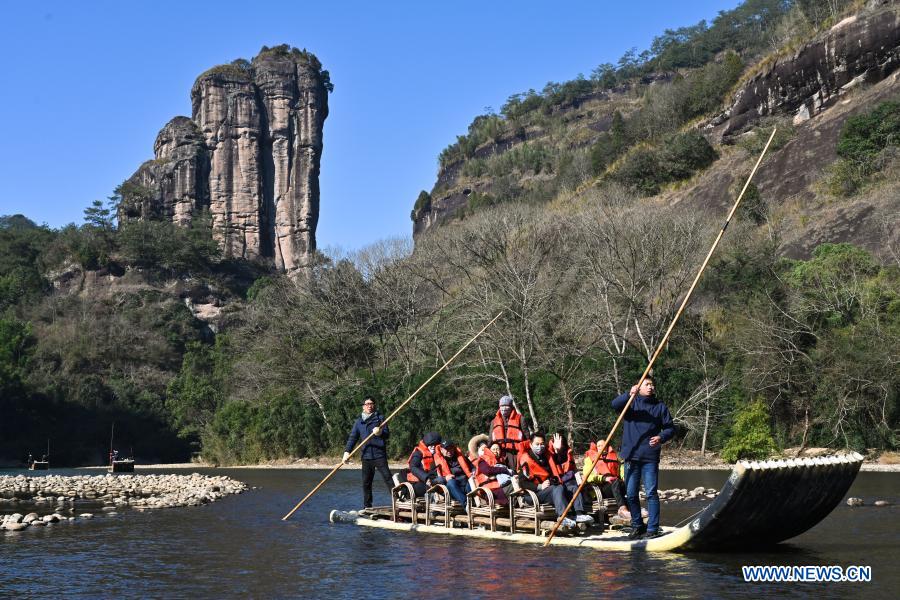 Tourists visit Wuyi Mountain scenic spot on a bamboo raft in southeast China's Fujian Province, Jan. 2, 2021. (Xinhua/Song Weiwei)