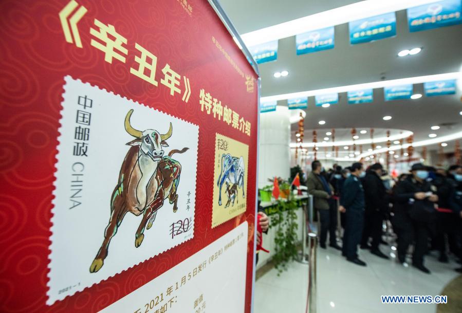 People queue up to buy the newly issued special stamps themed on the Year of the Ox at a post office in Guiyang, southwest China's Guizhou Province, Jan. 5, 2021. China Post on Tuesday issued a set of two special stamps to mark the upcoming Year of the Ox. (Xinhua/Tao Liang)
