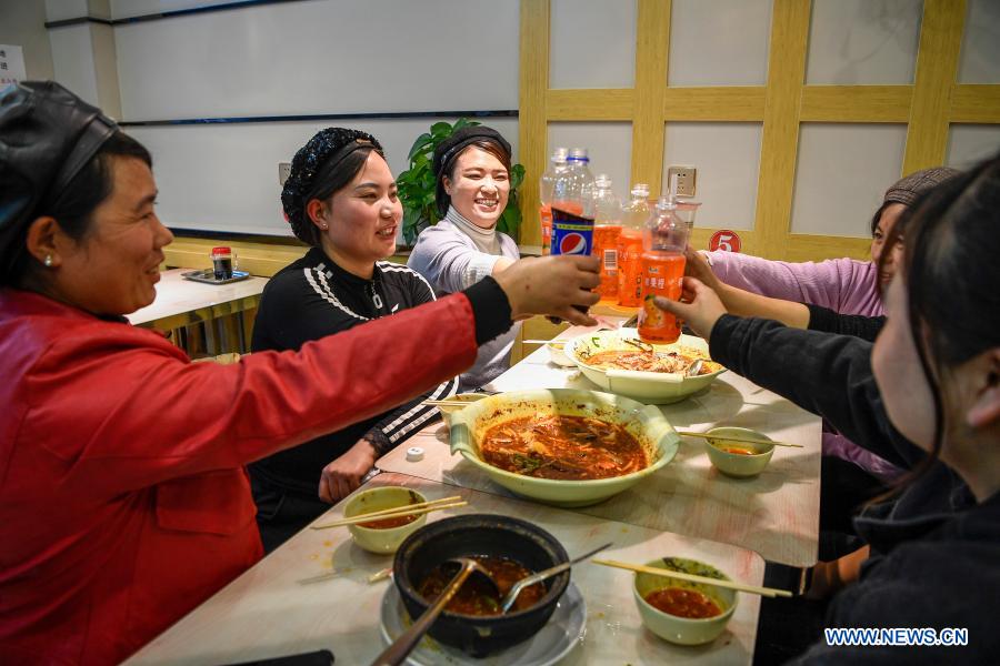 Members of a livestreaming team of Minning Hemei e-commerce poverty alleviation workshop celebrate after work in Yuanlong Village in Minning Township in Yinchuan, northwest China's Ningxia Hui Autonomous Region, Nov. 11, 2020. Xihaigu, one of China's most impoverished areas located in Ningxia, saw its last impoverished county removed from the national poverty list on Nov. 16, 2020. Over 60,000 farmers in Xihaigu have been relocated to Minning Township, which has converted from a town in Gobi desert to a modernized ecological relocation demonstration town over the past two decades via a series of cooperation between Ningxia and southeast China's Fujian Province. The victory is regarded as another landmark in China's campaign to eradicate absolute poverty, during which 