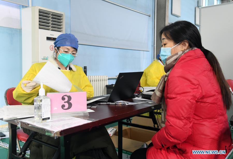 A woman registers for the COVID-19 vaccination at a temporary vaccination site in Haidian District of Beijing, capital of China, Jan. 6, 2021. (Xinhua/Ren Chao)
