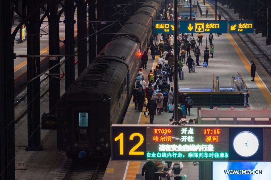 Passengers prepare to board train K7039 at Harbin Railway Station in Harbin, northeast China's Heilongjiang Province, Jan. 6, 2021. Train K7039, connecting Harbin, capital of Heilongjiang, and Mohe, China's northernmost city in Heilongjiang, runs a distance of 1,223 kilometers during the over 16-hour trip. Many passengers visit Mohe in winter to experience the extreme cold weather. The outside temperature drops to about minus 40 degrees Celsius while inside the train it remains over 20 degrees Celsius. (Xinhua/Xie Jianfei)