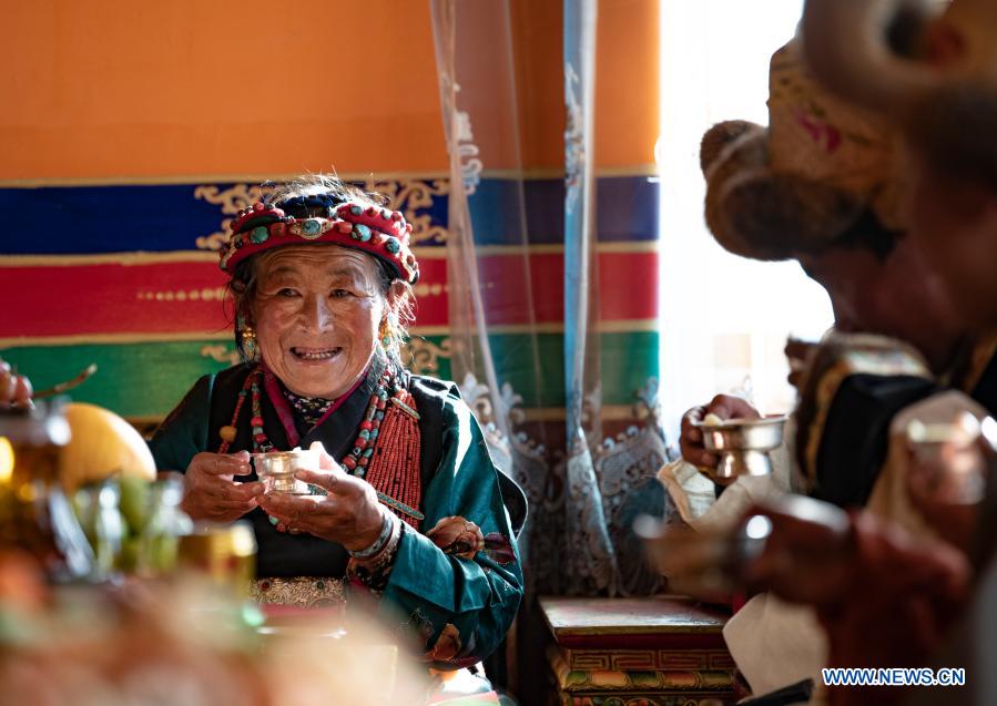 Villager Butri celebrates farmers' New Year in her new house in Gajilin Village of Chaqiug Township in Sa'gya County of Xigaze, southwest China's Tibet Autonomous Region, Jan. 14, 2021. Residents who were relocated from poverty-stricken area celebrate the farmers' New Year in their new homes in Gajilin Village. In Xigaze and other farming regions of Tibet, people celebrate New Year on the 1st day of the twelfth month of the Tibetan lunar calendar. According to local farming tradition, spring ploughing season always begins as the fall of New Year, thus celebrating one month earlier is to meet the needs of local agriculture. Xigaze City is regarded as a granary of Tibet. (Xinhua/Purbu Zhaxi)