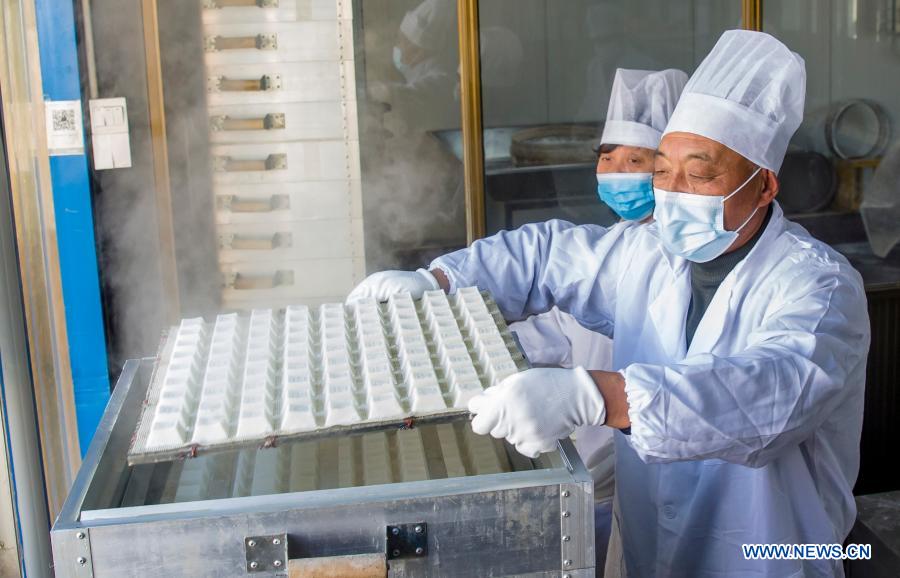 Workers move rice cakes out of the steamer at a food factory in Zhuangzhi Village of Haian, east China's Jiangsu Province, Jan. 16, 2021. Workers in Haian are busy making rice cakes to meet customers' growing demands as the Spring Festival approaches. (Photo by Xiang Zhonglin/Xinhua)