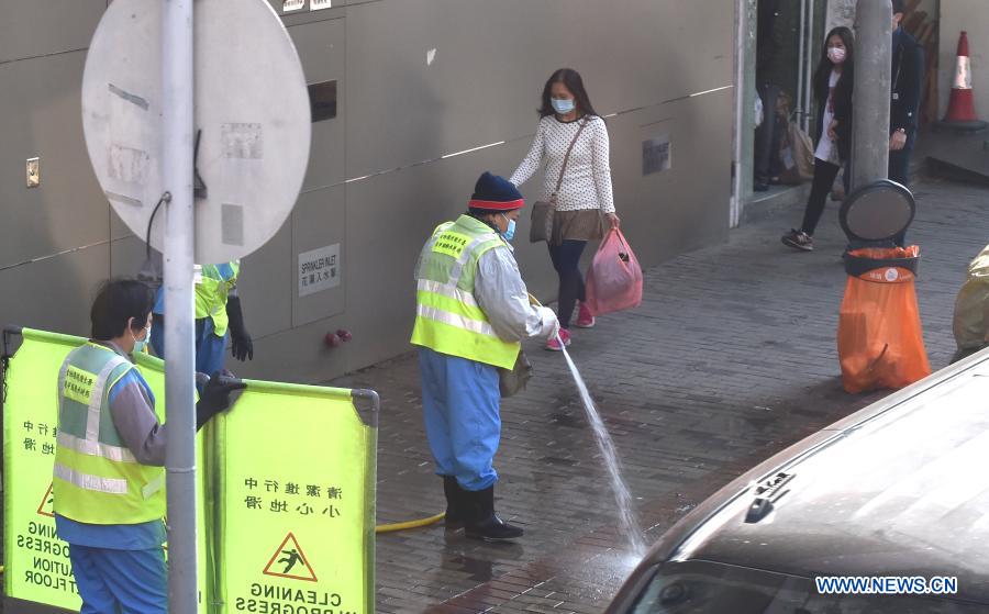 Sanitation workers clean the street in south China's Hong Kong, Jan. 18, 2021. Hong Kong's Center for Health Protection (CHP) reported 107 additional confirmed cases of COVID-19 on Monday, a new high in about one month. The new cases included 102 local infections and five imported ones, taking its total tally to 9,664. More than 40 of the new local cases were untraceable and there were about 50 cases tested positive preliminarily, according to a CHP press briefing. (Xinhua/Lo Ping Fai)