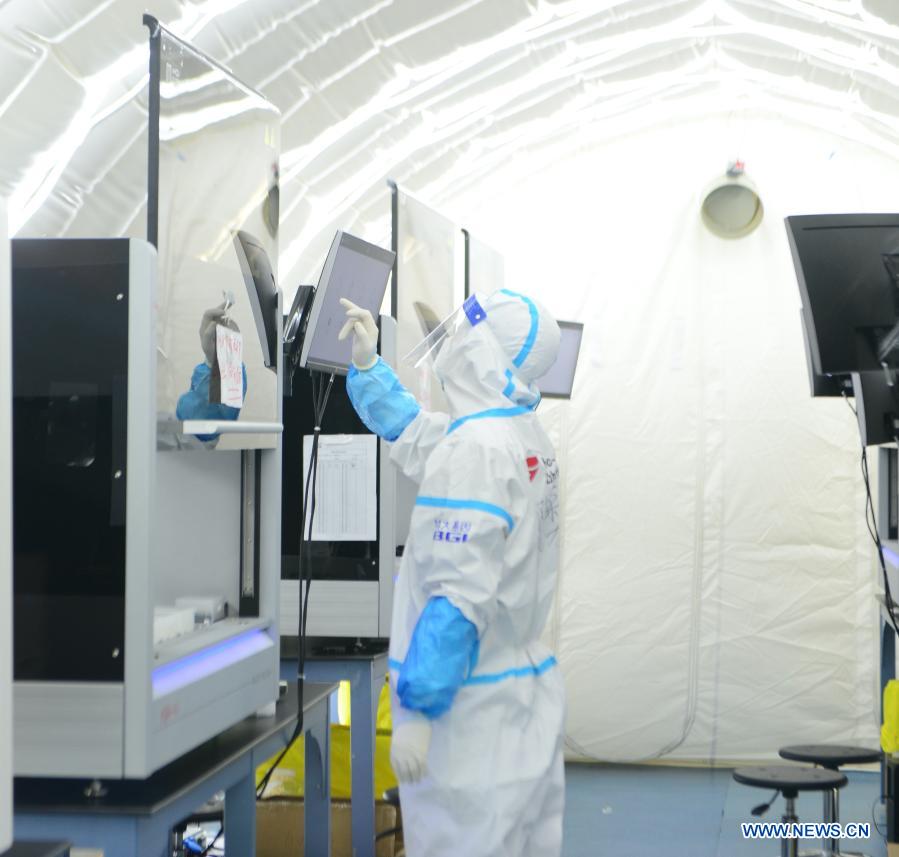 A staff member operates an automated nucleic acid extraction apparatus at the nucleic acid test laboratory named Huoyan, or Fire Eye, in Shijiazhuang, north China's Hebei Province, Jan. 18, 2021. On Jan. 8, a nucleic acid test laboratory named Huoyan, or Fire Eye, was built in only 10 hours and put into use in 21 hours in Shijiazhuang. It can test up to 1 million samples a day, significantly improving the city's testing capability. (Xinhua/Jin Haoyuan)