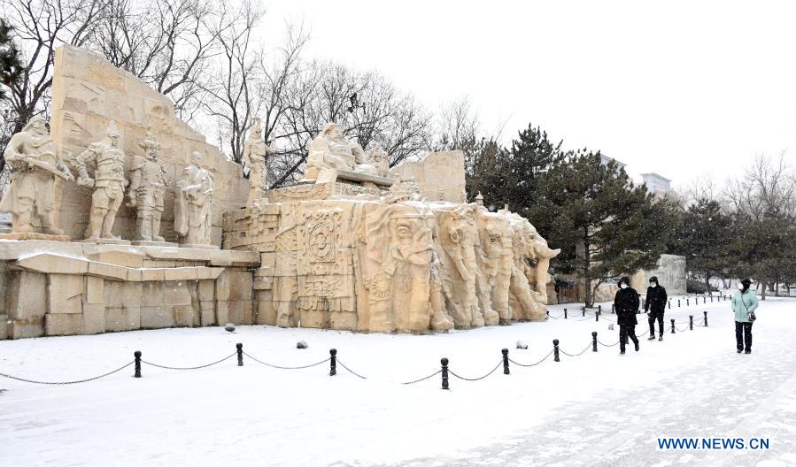 People walk in the snow-covered park in Beijing, capital of China, Jan. 19, 2021. (Xinhua/Ren Chao)