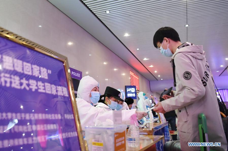 A returning traveller registers for a free ride service at Shijiazhuang Railway Station amid the COVID-19 pandemic in Shijiazhuang, north China's Hebei Province, Jan. 18, 2021. As all other public transportation services in Shijiazhuang were suspended for COVID-19 prevention and control purposes, local ride-hailing drivers have stepped forward and volunteered to help. Headed by 36-year-old Fan Yuejia, the 800-strong team of volunteer drivers is providing free rides to travellers arriving in the city in the run-up to the Chinese Lunar New Year. (Xinhua/Zhu Xudong)