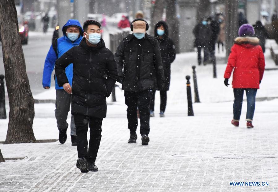 People walk in the snow in Beijing, capital of China, Jan. 19, 2021. (Xinhua/Ren Chao)