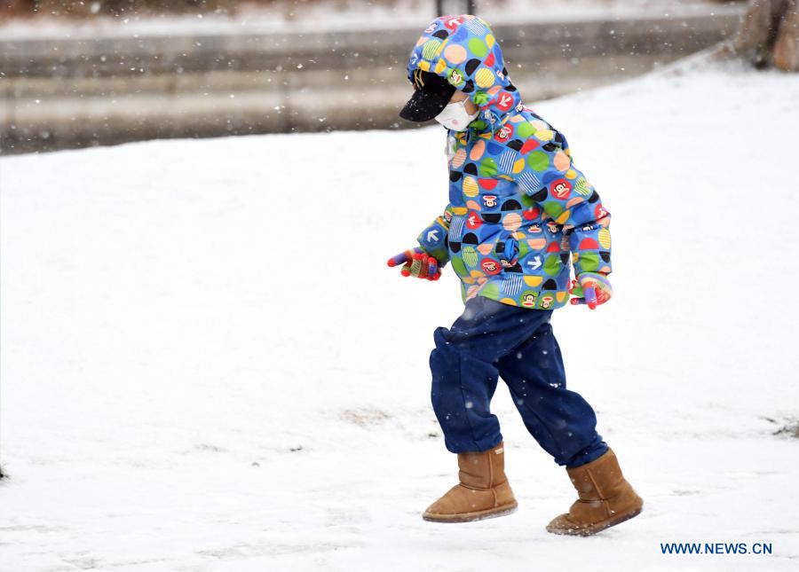A child plays in the snow-covered park in Beijing, capital of China, Jan. 19, 2021. (Xinhua/Ren Chao)