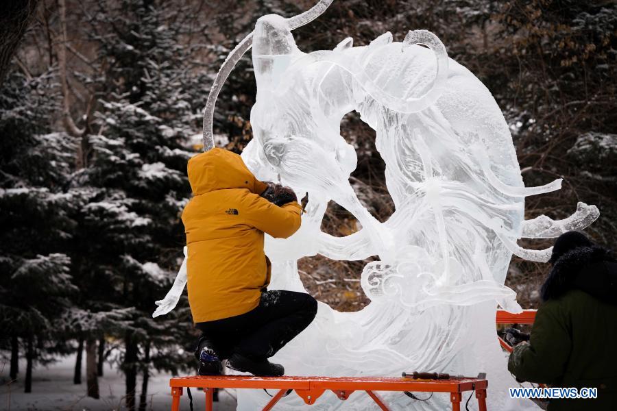 An ice sculptor works in the venue of the 47th Harbin ice lantern fair in Harbin, northeast China's Heilongjiang Province, Jan. 20, 2021. (Xinhua/Wang Song)