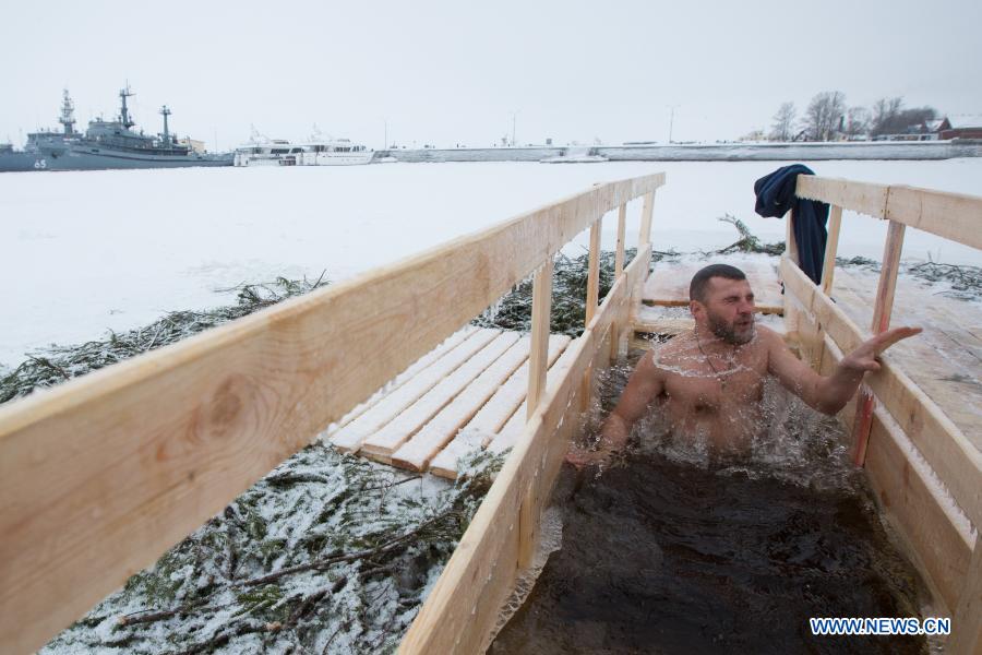 A man immerses himself in icy water during the Orthodox Epiphany celebrations in St. Petersburg, Russia, Jan. 19, 2021. (Photo by Irina Motina/Xinhua)