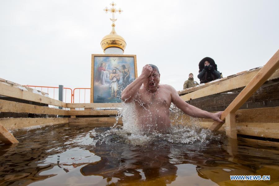 A man bathes in icy water during the Orthodox Epiphany celebrations in St. Petersburg, Russia, Jan. 19, 2021. (Photo by Irina Motina/Xinhua)