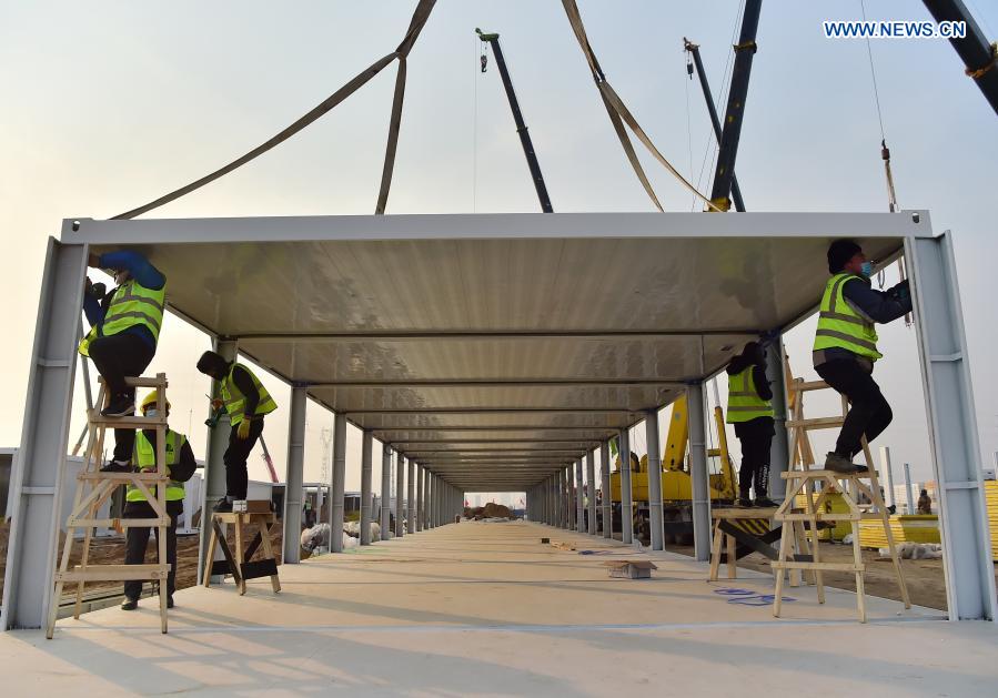 Workers work at the construction site of the Huangzhuang Apartment quarantine center in Shijiazhuang, north China's Hebei Province, Jan. 20, 2021. Located at the junction of Zhengding County and Gaocheng District in Shijiazhuang, the Huangzhuang Apartment COVID-19 quarantine center project has an area of 658 mu (about 43.87 hectares), and a capacity of 4,156 rooms, which is used to accommodate close contacts and sub-close contacts of confirmed COVID-19 patients. (Xinhua/Yang Shiyao)