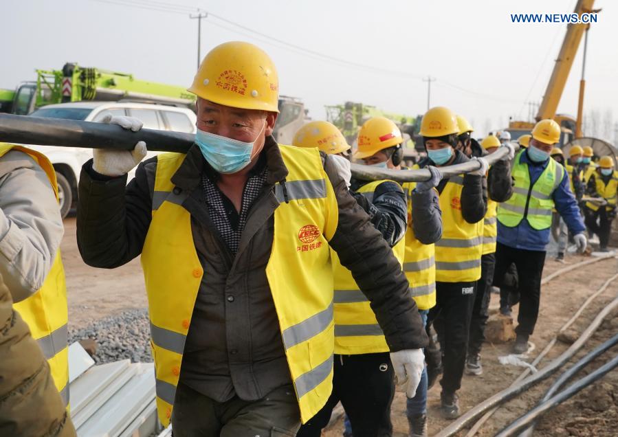 Workers work at the construction site of the Huangzhuang Apartment quarantine center in Shijiazhuang, north China's Hebei Province, Jan. 20, 2021. Located at the junction of Zhengding County and Gaocheng District in Shijiazhuang, the Huangzhuang Apartment COVID-19 quarantine center project has an area of 658 mu (about 43.87 hectares), and a capacity of 4,156 rooms, which is used to accommodate close contacts and sub-close contacts of confirmed COVID-19 patients. (Xinhua/Yang Shiyao)