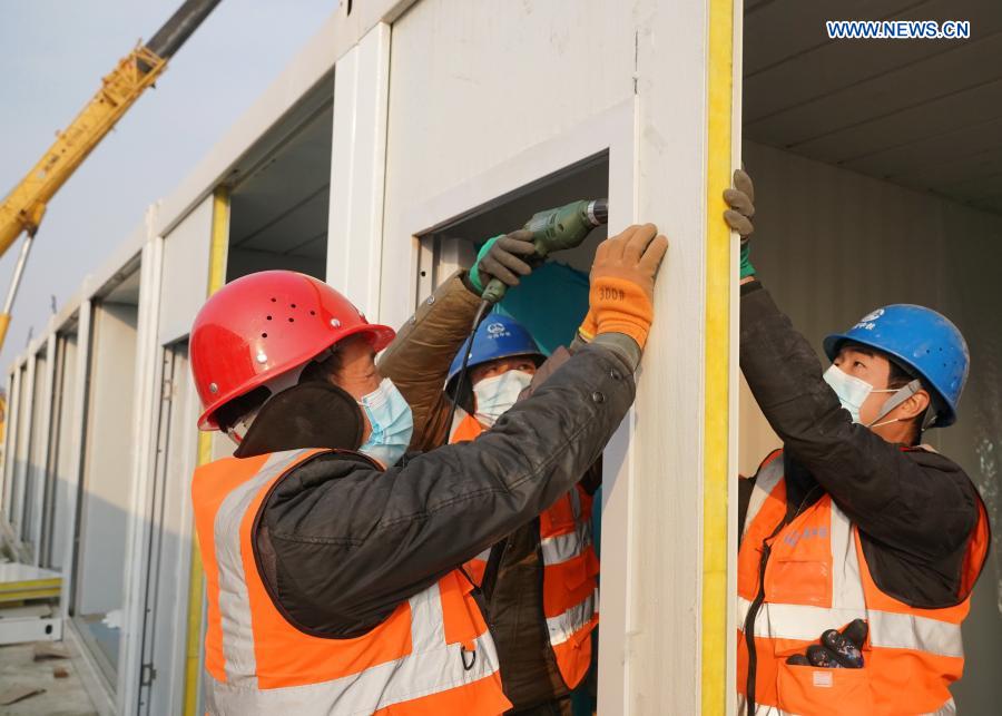 Workers work at the construction site of the Huangzhuang Apartment quarantine center in Shijiazhuang, north China's Hebei Province, Jan. 20, 2021. Located at the junction of Zhengding County and Gaocheng District in Shijiazhuang, the Huangzhuang Apartment COVID-19 quarantine center project has an area of 658 mu (about 43.87 hectares), and a capacity of 4,156 rooms, which is used to accommodate close contacts and sub-close contacts of confirmed COVID-19 patients. (Xinhua/Yang Shiyao)