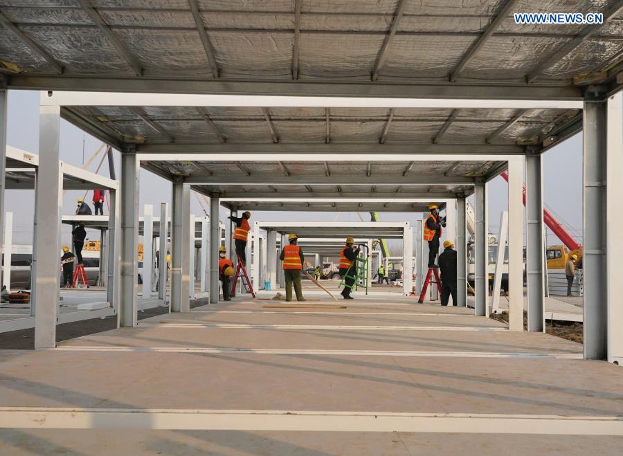 Workers work at the construction site of the Huangzhuang Apartment quarantine center in Shijiazhuang, north China's Hebei Province, Jan. 20, 2021. Located at the junction of Zhengding County and Gaocheng District in Shijiazhuang, the Huangzhuang Apartment COVID-19 quarantine center project has an area of 658 mu (about 43.87 hectares), and a capacity of 4,156 rooms, which is used to accommodate close contacts and sub-close contacts of confirmed COVID-19 patients. (Xinhua/Yang Shiyao)