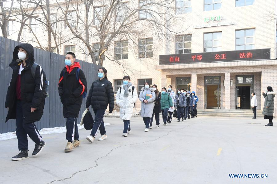 Students on the third grade of the junior section of the High School Affiliated to China Agricultural University walk in line as they leave campus in Beijing, capital of China, Jan. 21, 2021. All primary schools in Beijing have been on winter vacation since Jan. 16. Classes on the first and second grades of junior sections of high schools here are slated to start their winter vacations as of Jan. 23. Classes on all other grades of high schools are expected to complete their off-line academic activities by Jan. 23, and all students on these classes will no longer attend on-campus activities as of the same date. (Xinhua/Ren Chao)