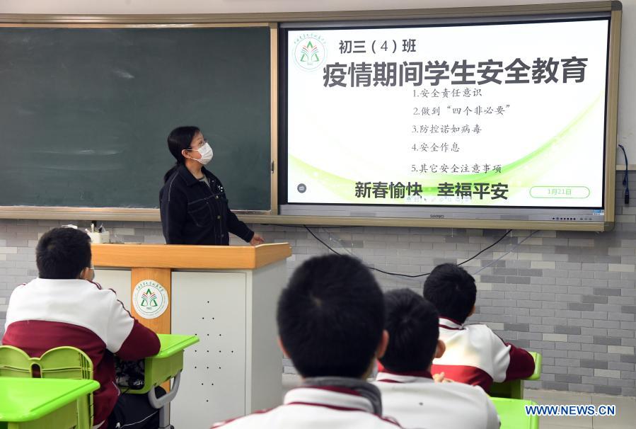 Students on the third grade of the junior section of the High School Affiliated to China Agricultural University receive instructions on COVID-19 prevention and control before leaving campus in Beijing, capital of China, Jan. 21, 2021. All primary schools in Beijing have been on winter vacation since Jan. 16. Classes on the first and second grades of junior sections of high schools here are slated to start their winter vacations as of Jan. 23. Classes on all other grades of high schools are expected to complete their off-line academic activities by Jan. 23, and all students on these classes will no longer attend on-campus activities as of the same date. (Xinhua/Ren Chao)