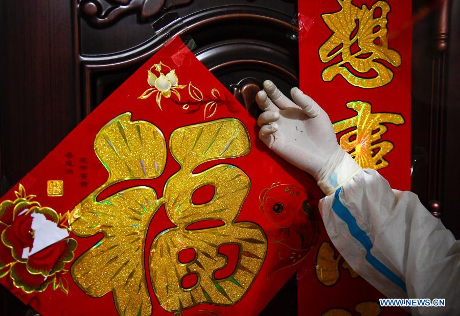 A medical worker knocks the door of a family to collect swab samples for COVID-19 screening at a residential area in Dongchang District of Tonghua, northeast China's Jilin Province, Jan. 25, 2021. Tonghua on Monday launched the third round of citywide nucleic acid testing. (Xinhua/Xu Chang)