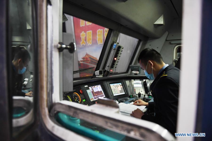 A train driver makes preparations before departure on the train 3603 from Beijing to Chongqing, in Beijing, capital of China, Jan. 28, 2021. The Spring Festival travel rush, known as the world's largest annual human migration, lasts 40 days from Jan. 28 to March 8 this year. (Xinhua/Zhang Chenlin)