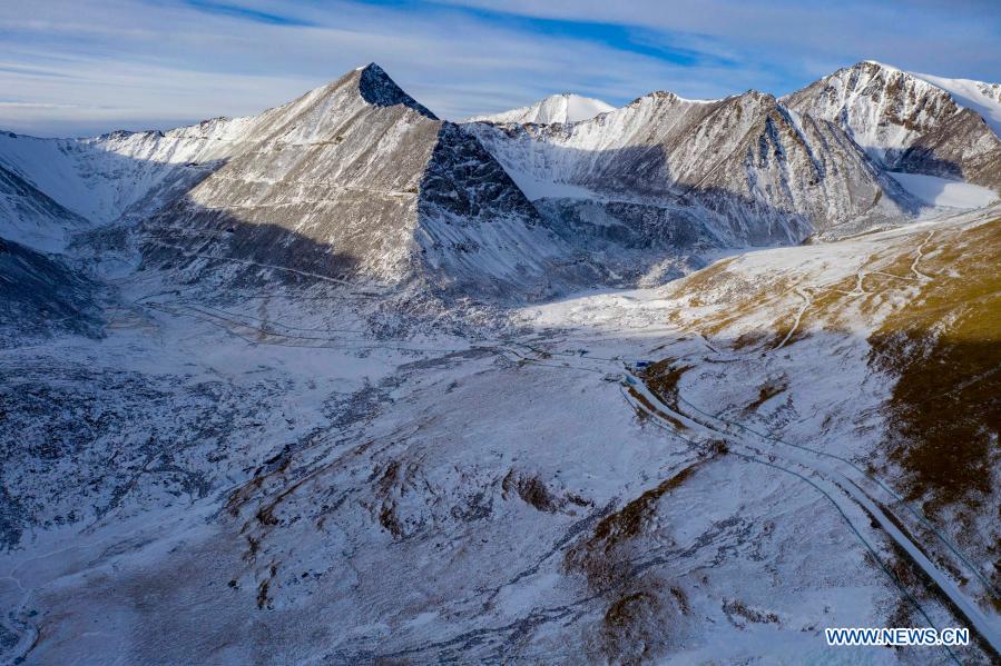 Aerial photo taken on Feb. 5, 2021 shows a view of the snow-covered Tianshan Shengli Daban in northwest China's Xinjiang Uygur Autonomous Region. Tianshan Shengli tunnel, with a total length of about 22 kilometers, is currently the longest highway tunnel under construction in China. Started in 2020, the tunnel, a six-year project on the Urumqi-Yuli highway, passes through a cold and high altitude zone, with harsh climate and geological condition. After completion and opened to traffic, it will provide safer and more convenient travel to the passengers and promote local economic and social development. (Xinhua/Hu Huhu)