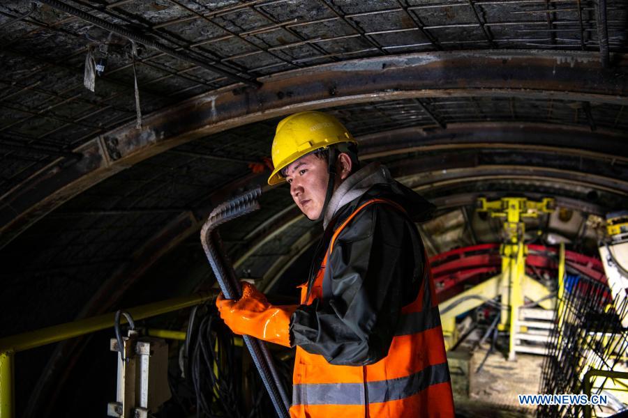 A worker is seen at the construction site of Tianshan Shengli tunnel in northwest China's Xinjiang Uygur Autonomous Region, Feb. 4, 2021. Tianshan Shengli tunnel, with a total length of about 22 kilometers, is currently the longest highway tunnel under construction in China. Started in 2020, the tunnel, a six-year project on the Urumqi-Yuli highway, passes through a cold and high altitude zone, with harsh climate and geological condition. After completion and opened to traffic, it will provide safer and more convenient travel to the passengers and promote local economic and social development. (Xinhua/Hu Huhu)